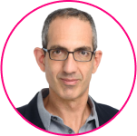A man with short dark hair, wearing glasses, a gray collared shirt, and a dark jacket, is pictured against a white background with a pink circular border—perfect for discussing SSO myths or Single Sign-On best practices.
